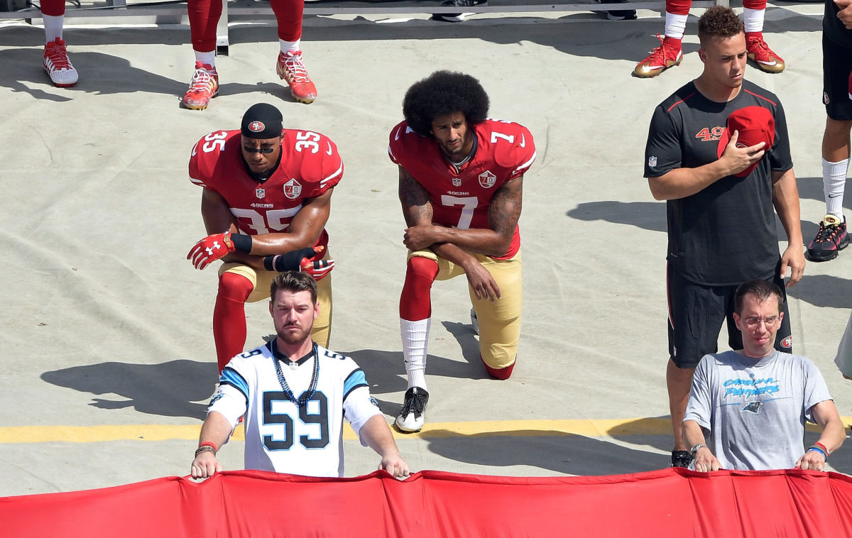 Colin Kaepernick kneels during an NFL game.