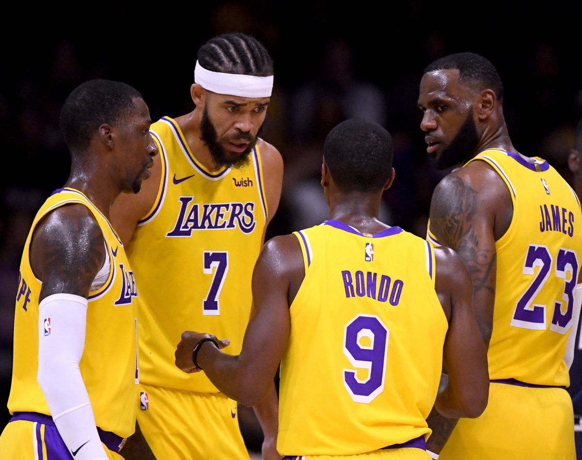 lakers players join together during a preseason game