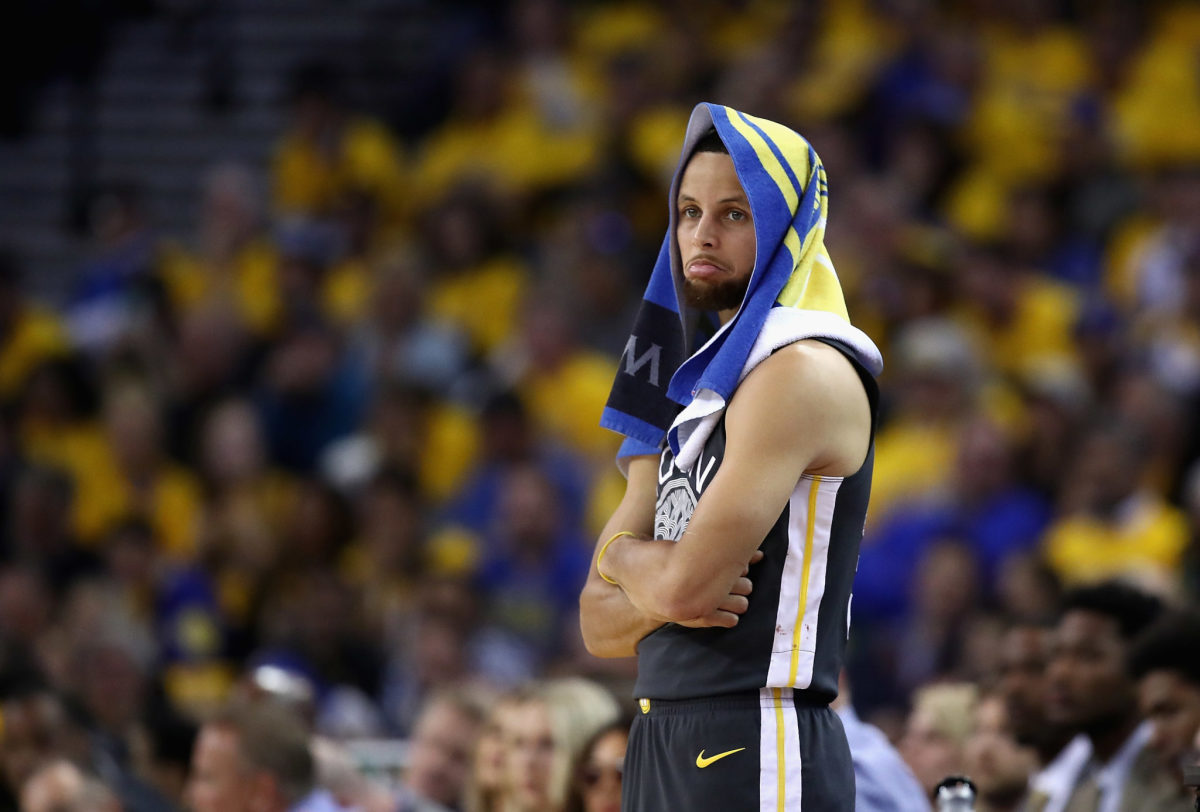 Steph Curry with a towel on his head.