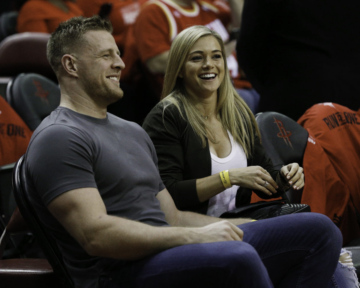 jj watt and his fiancee at a houston rockets game