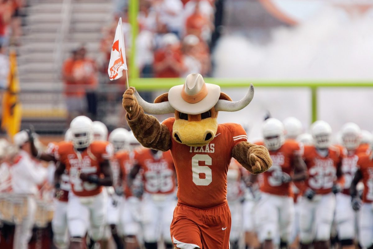 Texas' mascot leading the team onto the field.