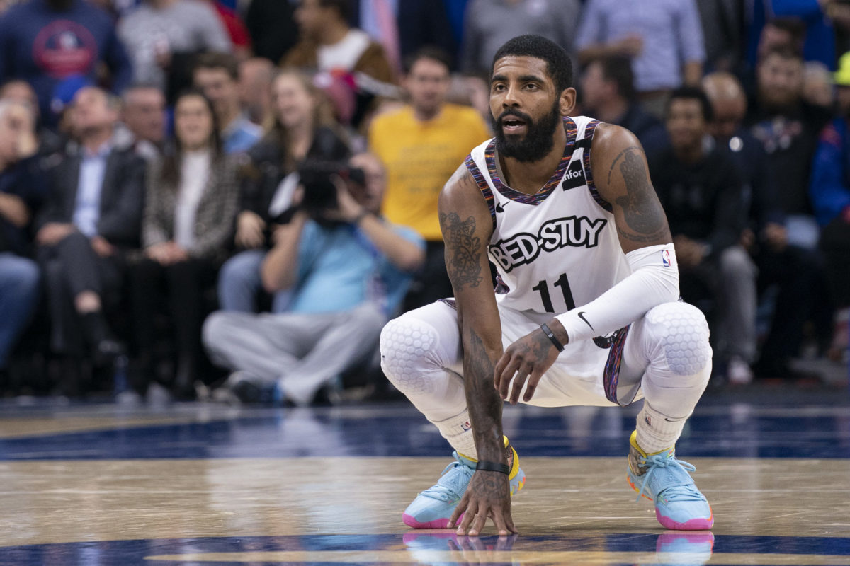 Kyrie Irving on the floor for the Brooklyn Nets during an NBA game.
