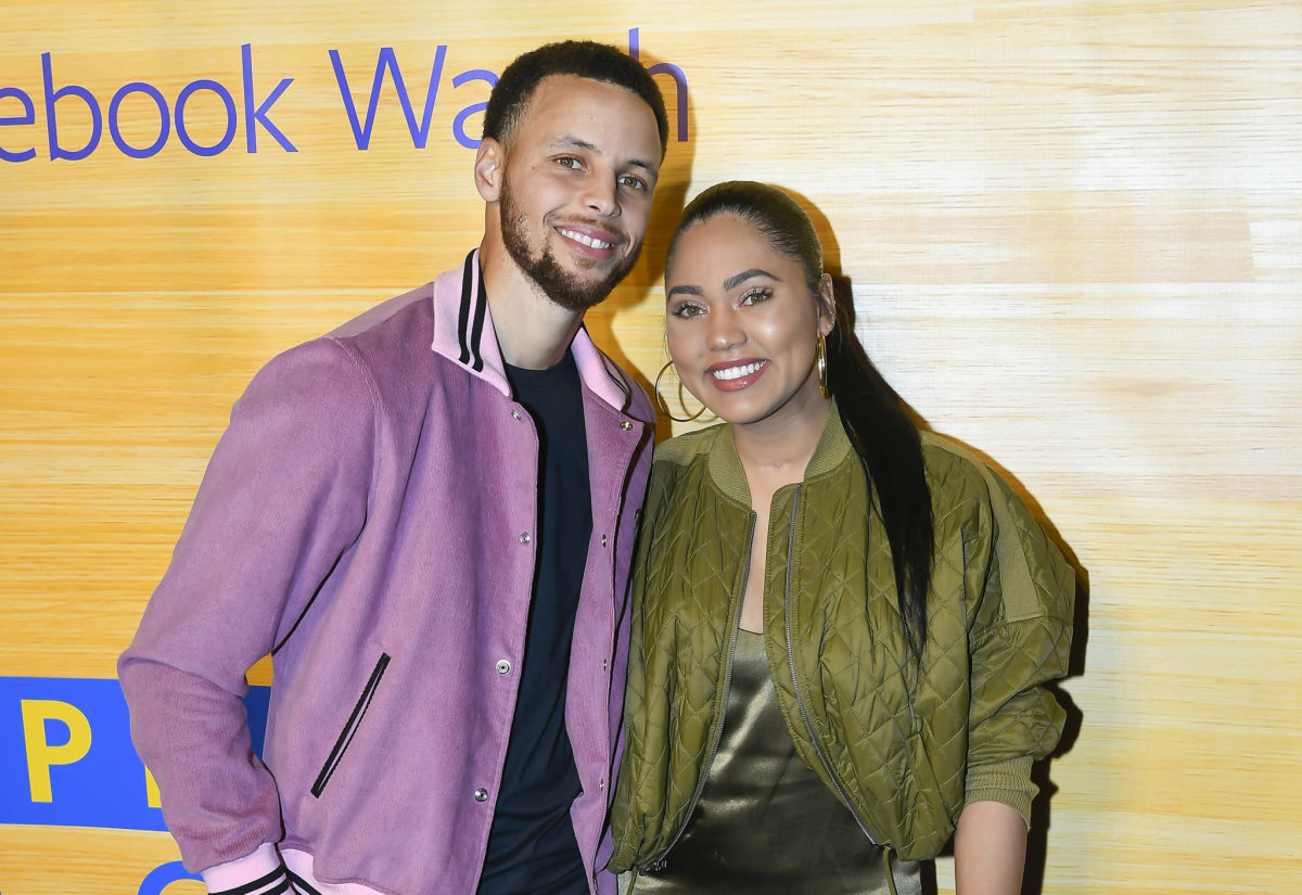 Steph and Ayesha Curry pose for a photo.