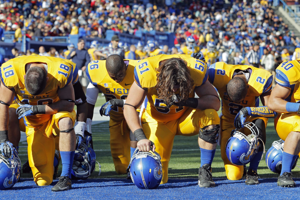 San Jose State players pray in the end zone before a game.
