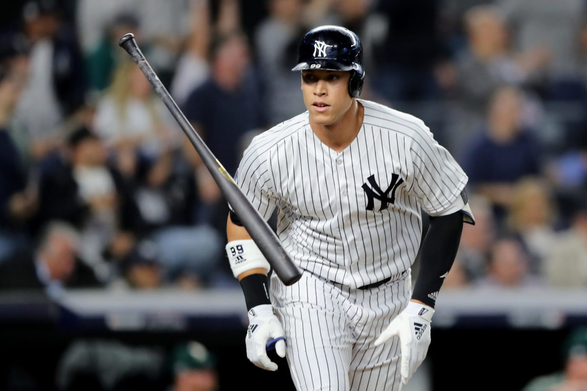 New York Yankees OF Aaron Judge flipping his baseball bat after hitting a home run.