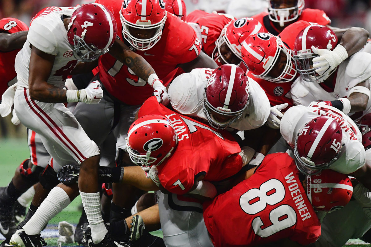 Alabama players tackling Georgia running back D'Andre Swift during the SEC college football championship game.