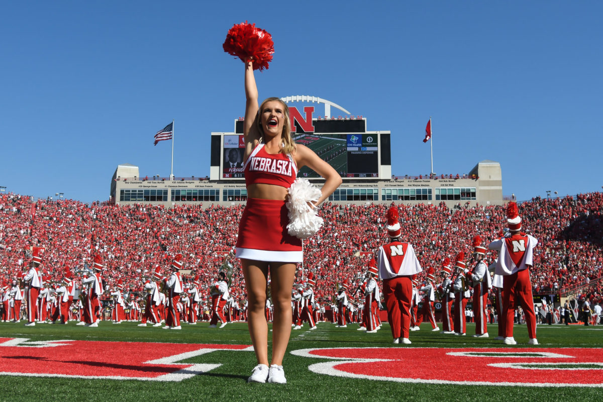 A Nebraska cheerleader cheers in the end zone against Troy.