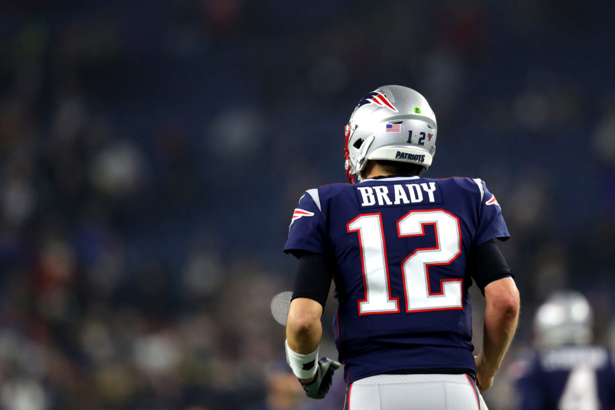 New England Patriots quarterback Tom Brady runs onto the field.