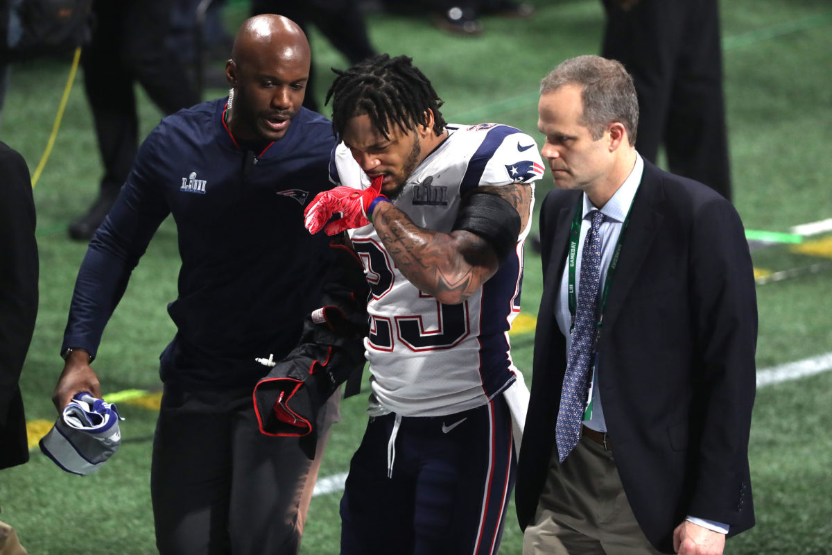 Patrick Chung of the Patriots walks off the field after injuring his arm in the Super Bowl.