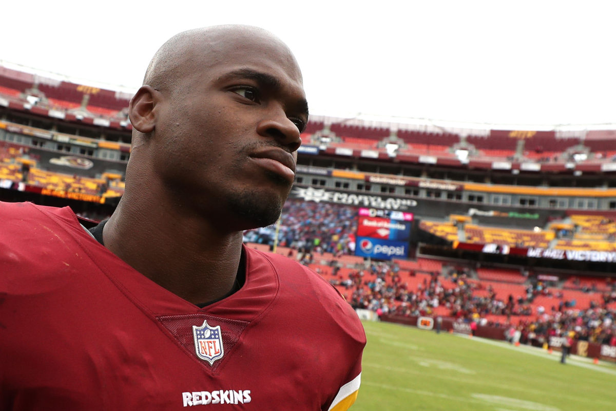 adrian peterson looks onto the field with the redskins