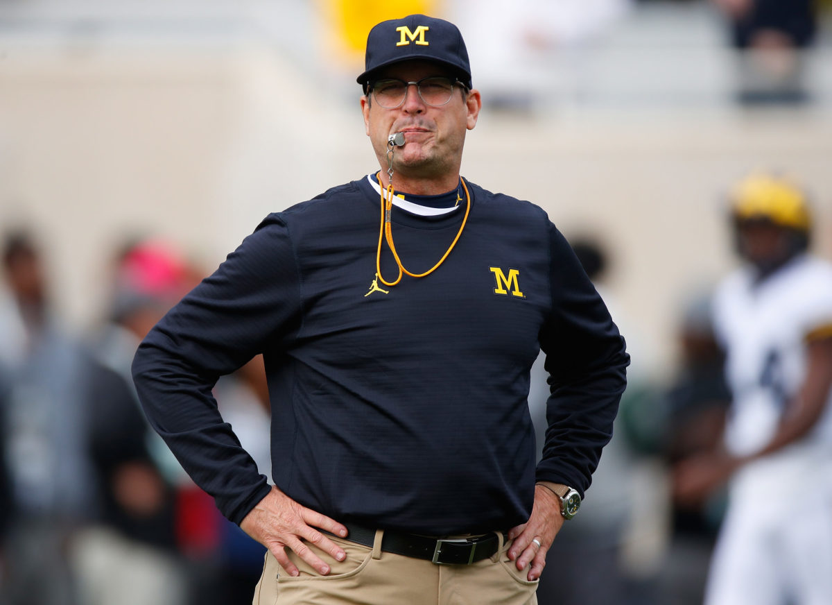 Head coach Jim Harbaugh of the Michigan Wolverines blows whistle before start of the game.