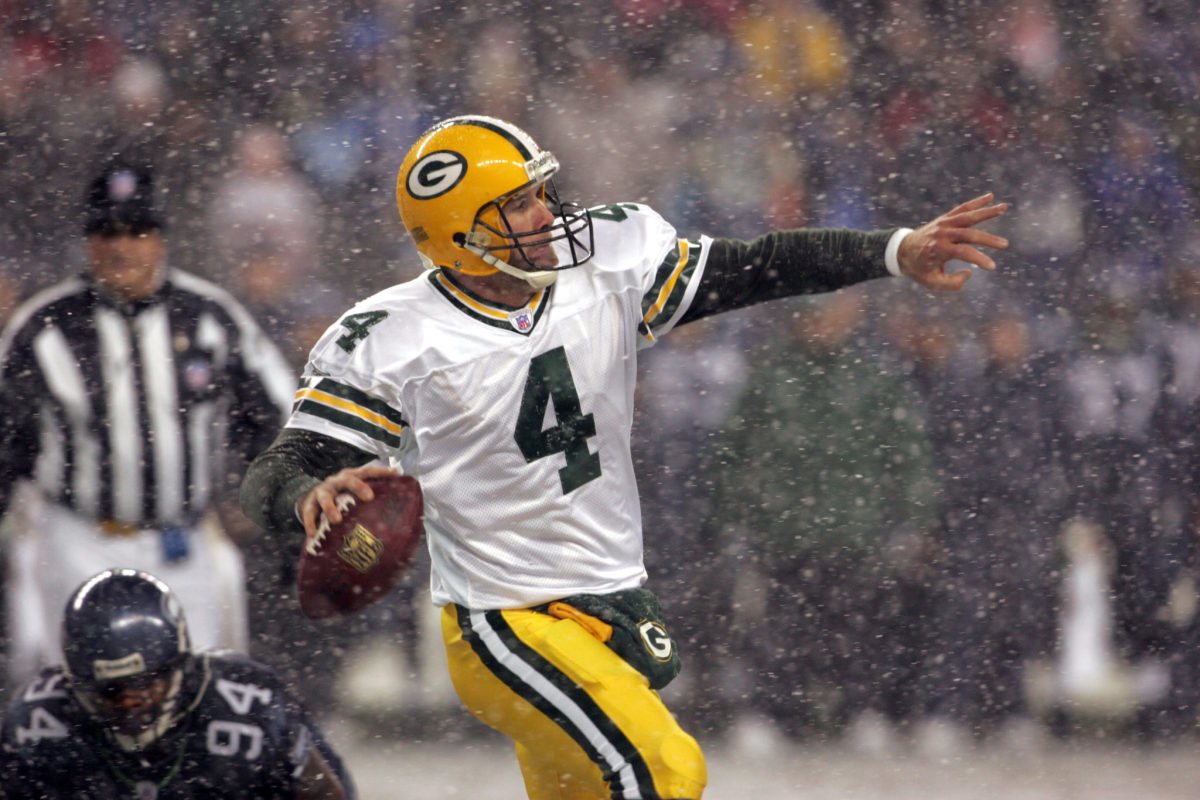 Bret Favre throwing a pass during a game in the snow.