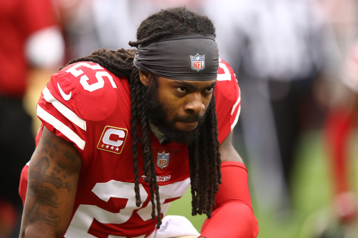 Richard Sherman takes a knee during a game for the San Francisco 49ers.