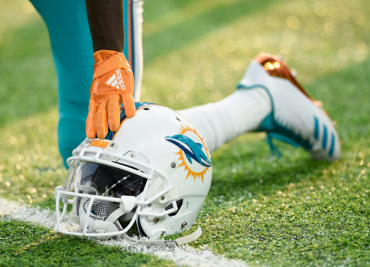 A Miami Dolphins helmet sitting on the field.