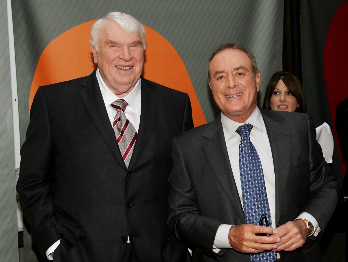 John Madden and Al Michaels posing for a photo.