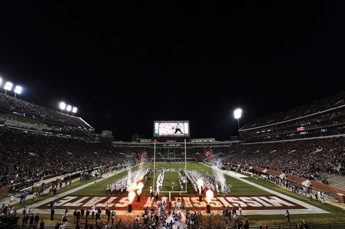 Mississippi State football's players run onto the field.