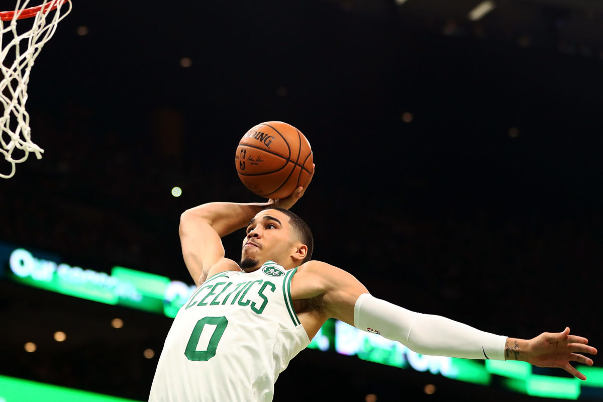 Boston Celtics star Jayson Tatum dunking the ball.
