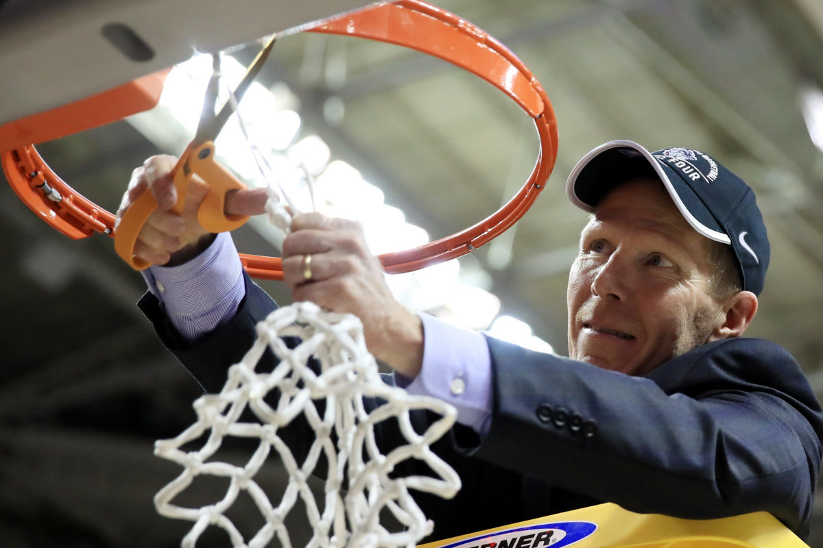 Gonzaga basketball coach Mark Few cutting down a net after an NCAA Tournament victory.