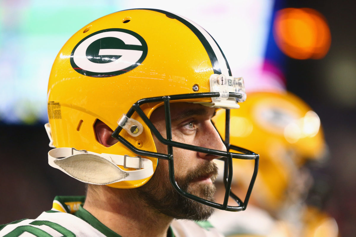 A closeup of Aaron Rodgers wearing a Green Bay Packers helmet.
