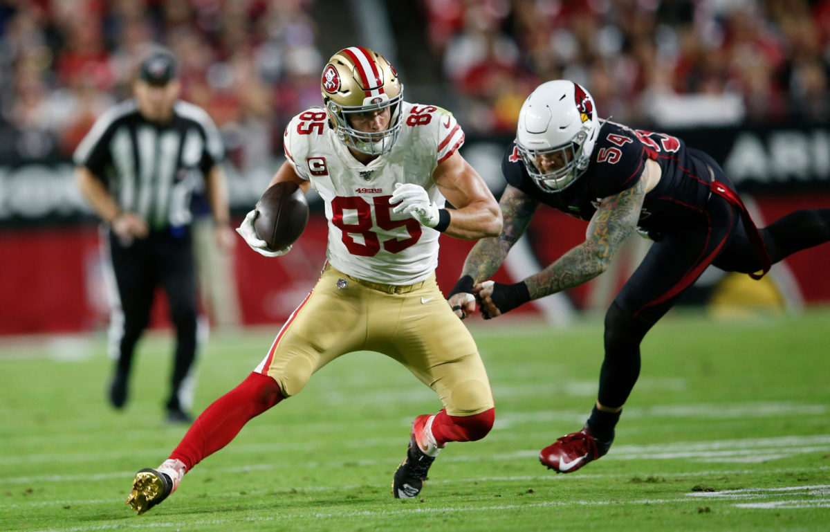 George Kittle runs with the football for the San Francisco 49ers.