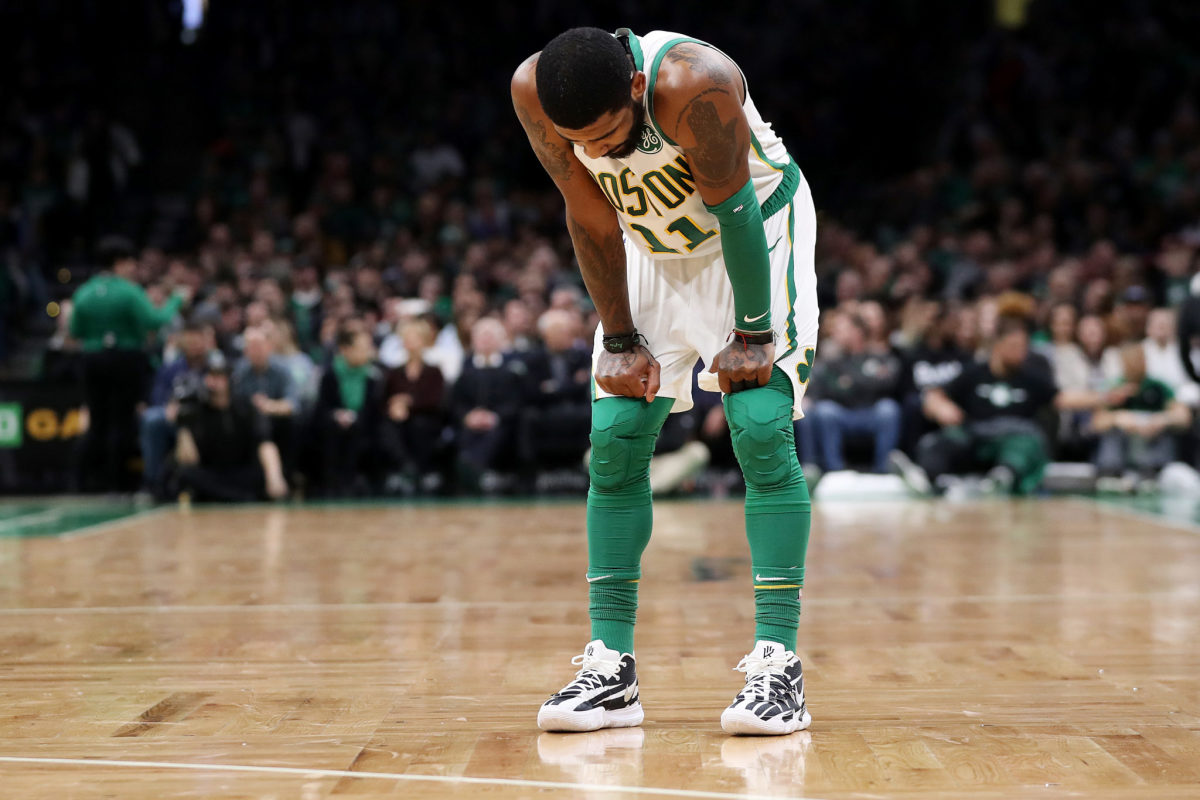 Kyrie Irving standing with his hands on his knees during a game.