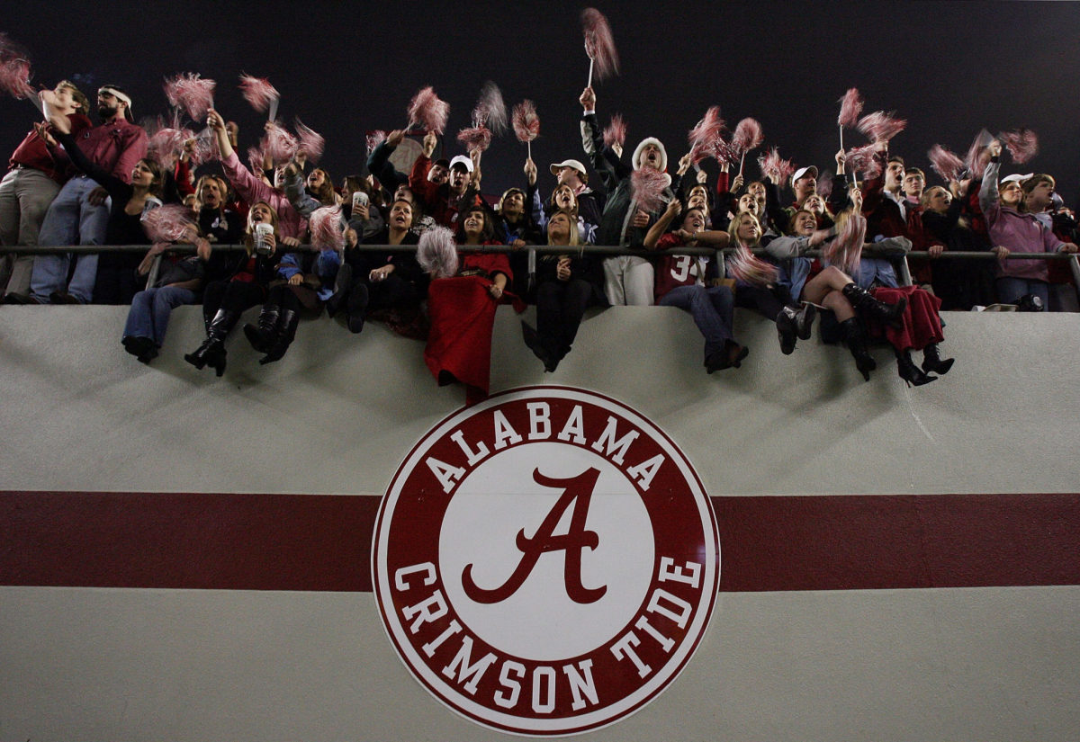 Alabama fans cheer after the Alabama Crimson Tide defeat the Auburn Tigers at Bryant-Denny Stadium.