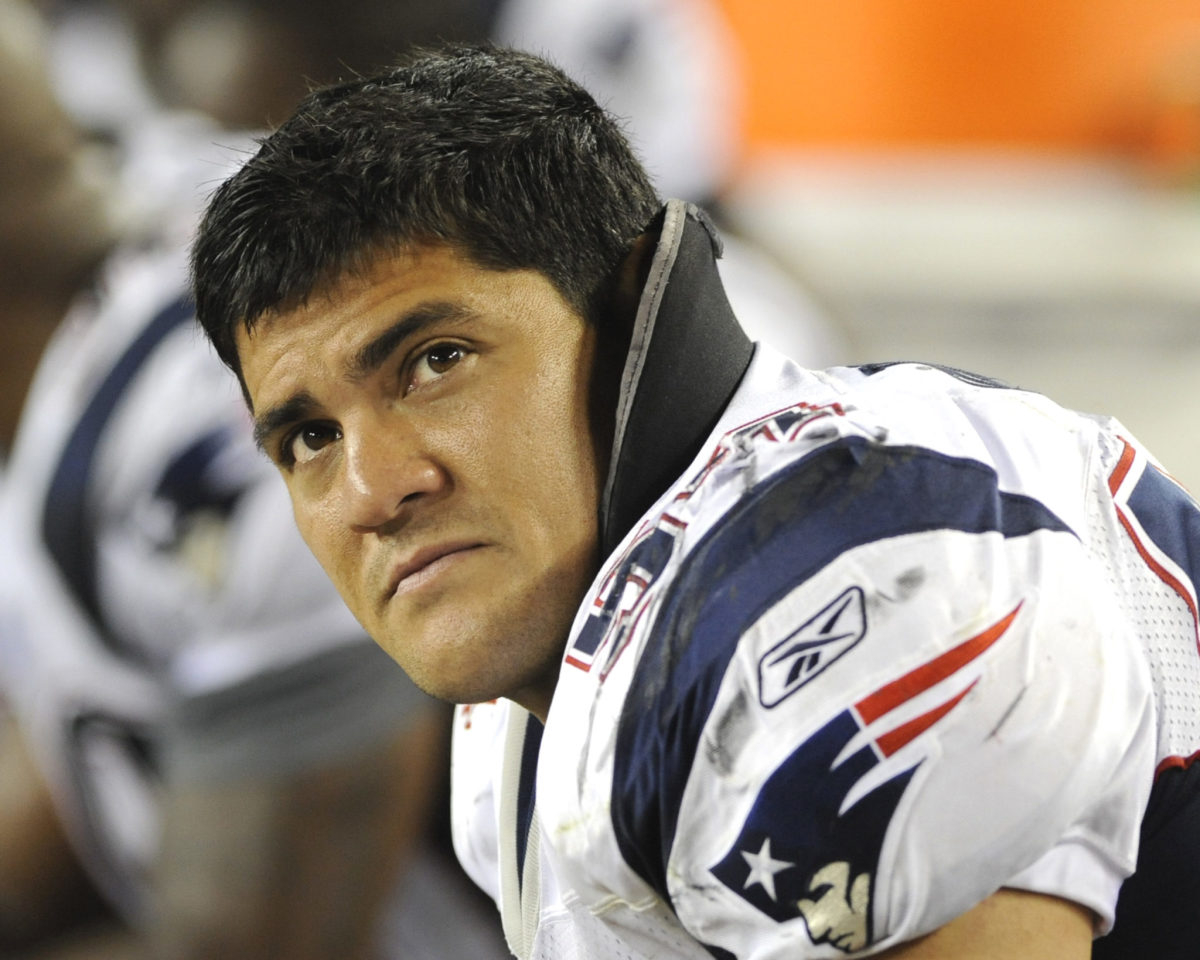 Tedy Bruschi sits on the Patriots bench.