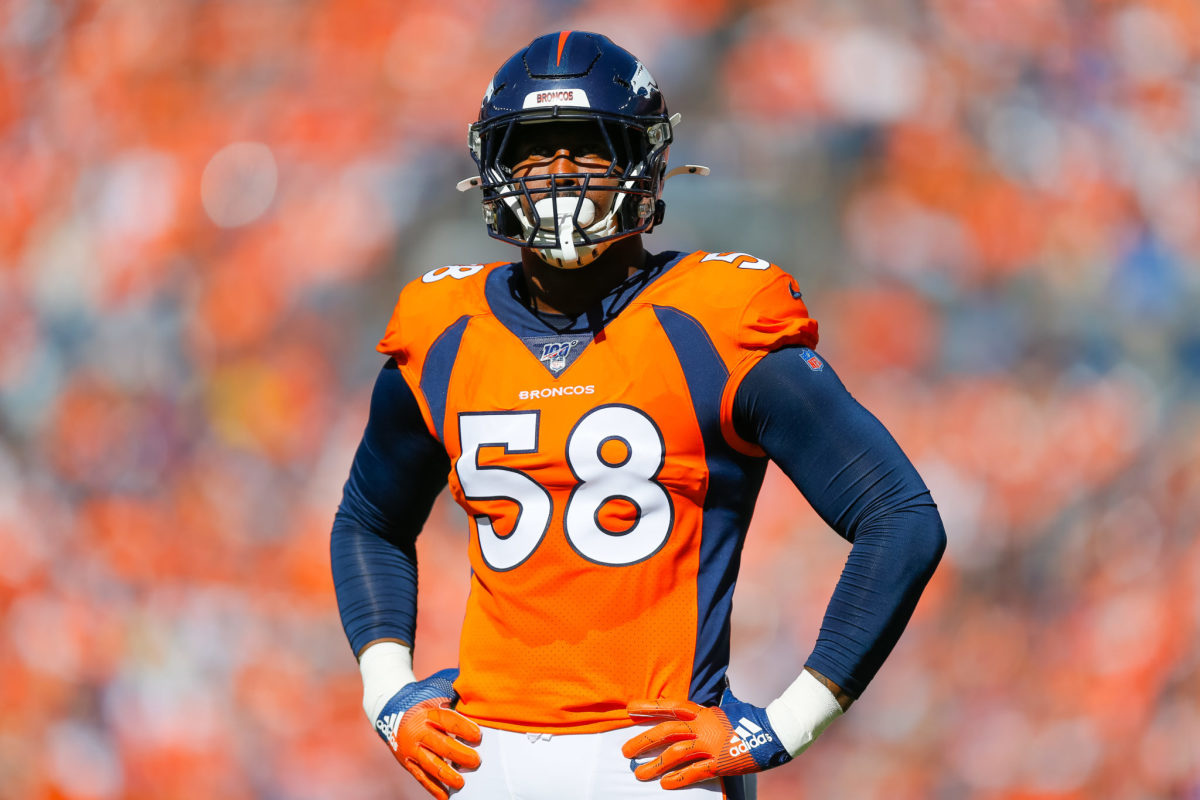 Von Miller stands with hands on hips during a Broncos game.