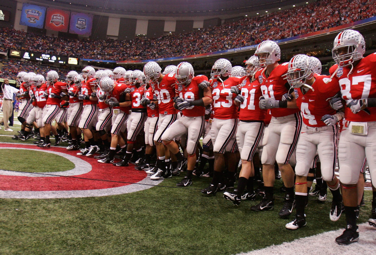 Ohio State football players locking arms before a game.