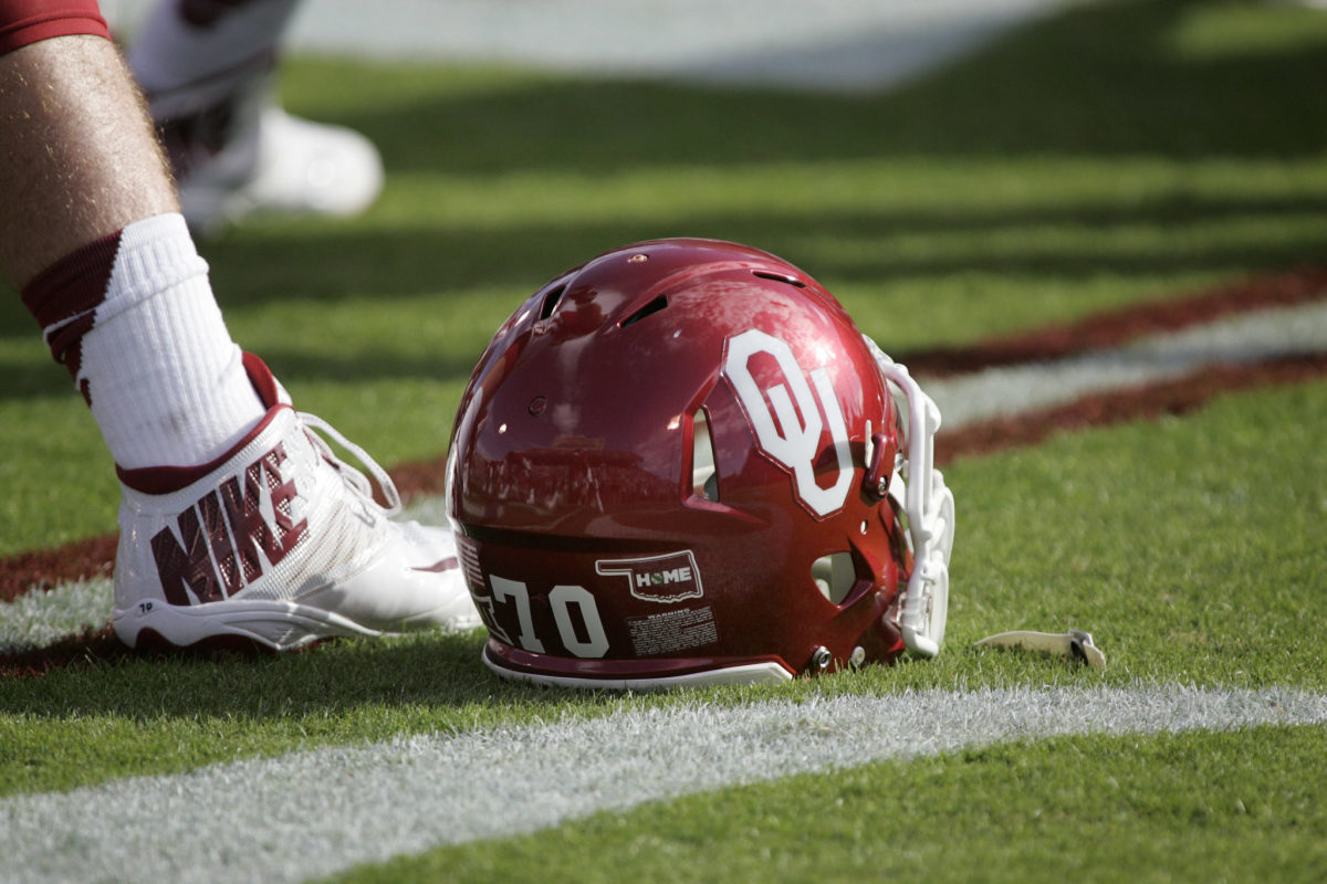 An Oklahoma Sooners football helmet on the field.