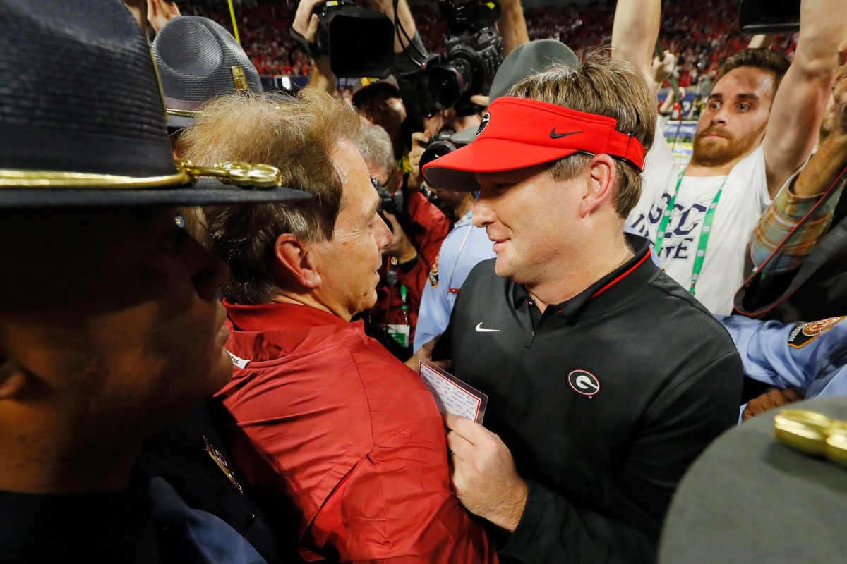 Kirby Smart and Nick Saban speaking after a n SEC Championship football game.