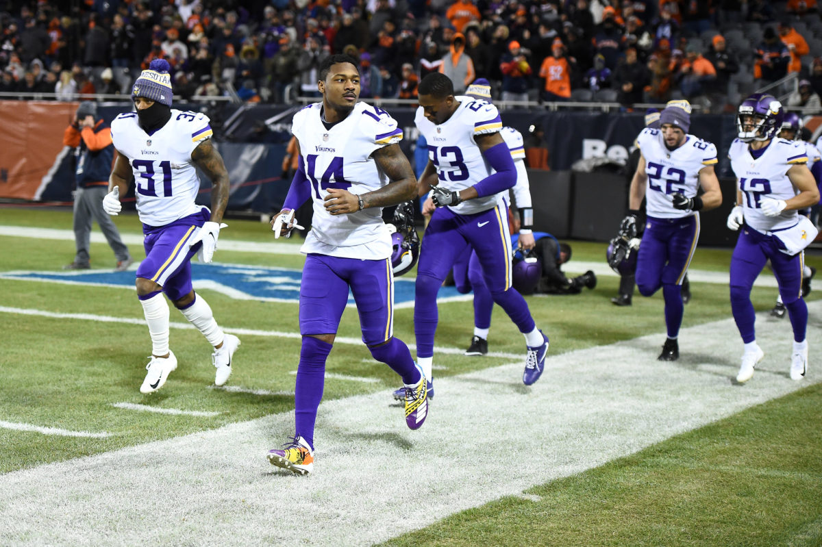 Stefon Diggs leading his Vikings teammates onto the field.