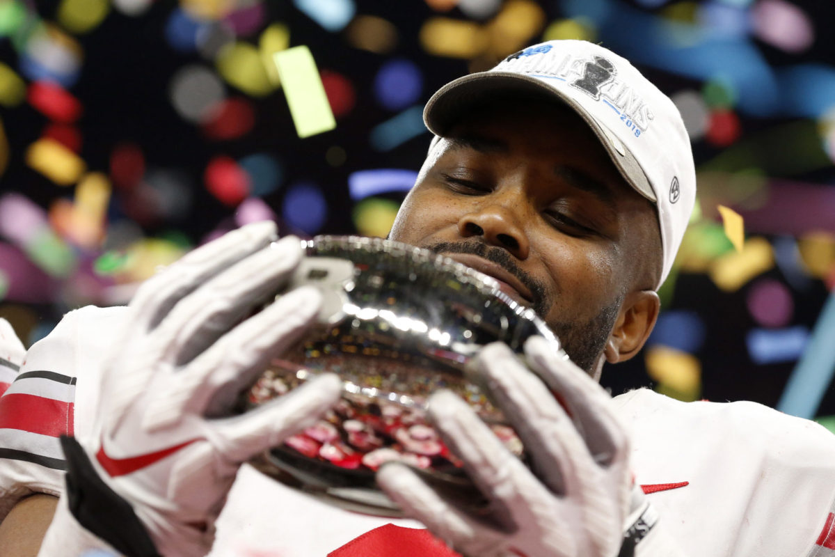 K.J. Hill of Ohio State celebrates with Big Ten Championship Trophy.