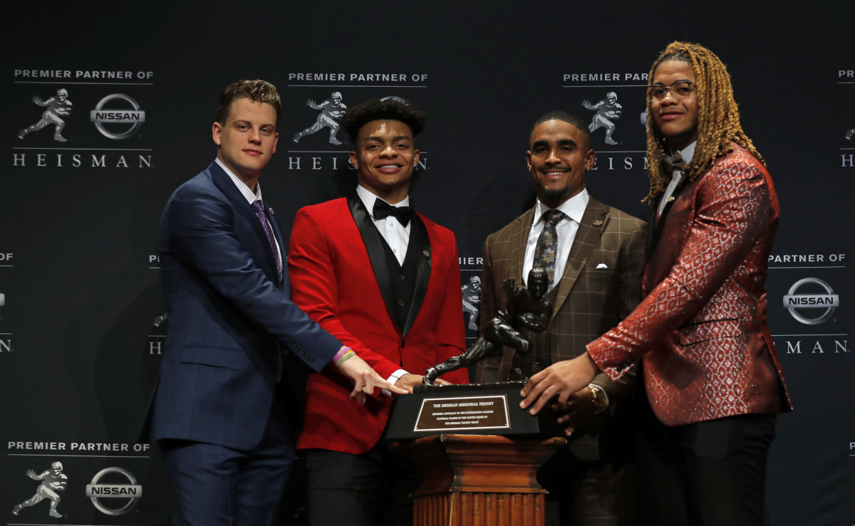 The 2019 Heisman Trophy finalists including Justin Fields with the trophy.
