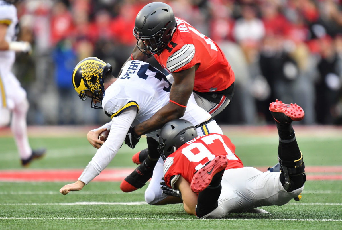 Nick Bosa and Jalyn Holmes of the Ohio State Buckeyes sack Wilton Speight #3 of the Michigan Wolverines.