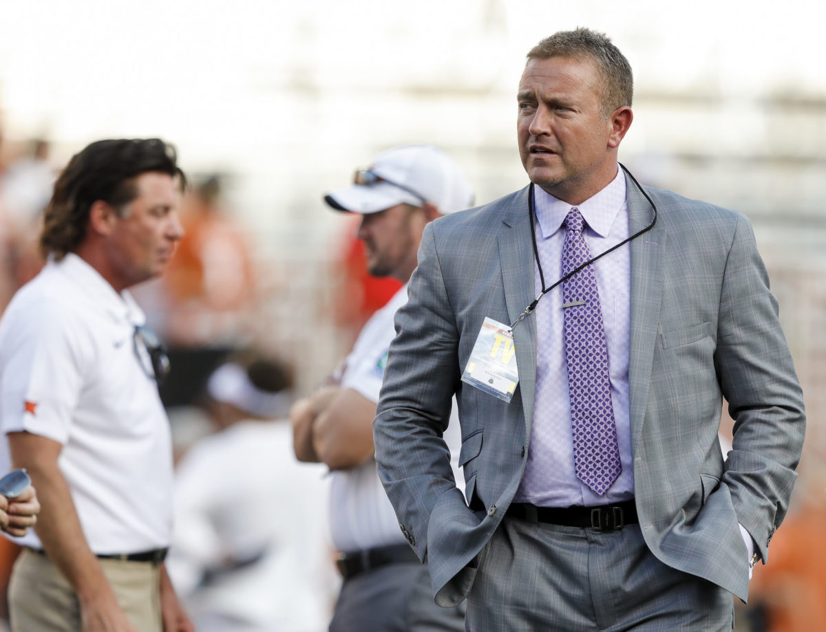 Kirk Herbstreit walks on the field before the college football game between Texas and Oklahoma State.