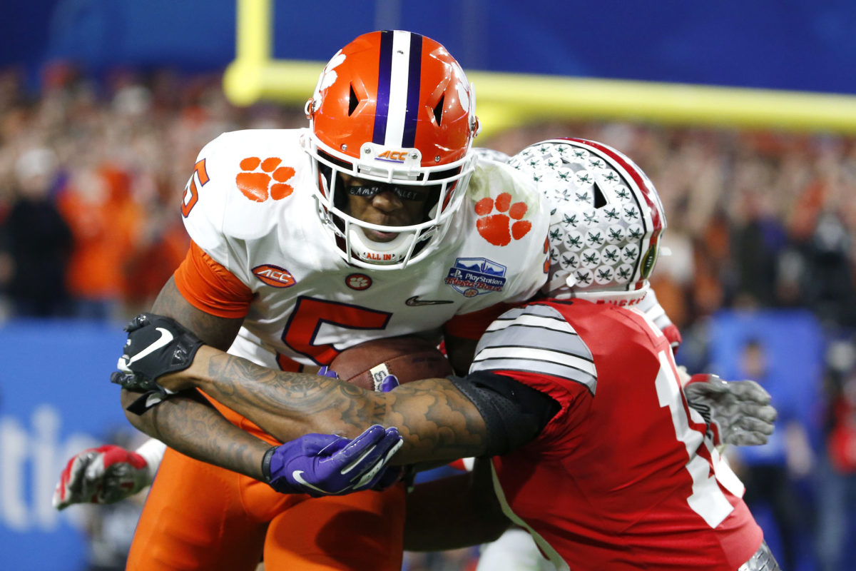 An Ohio State player tackles Clemson's Tee Higgins.