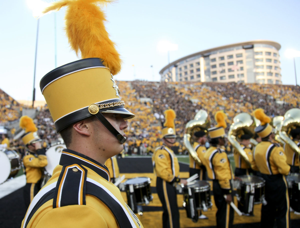 A member of Iowa marching band performing during a football game.