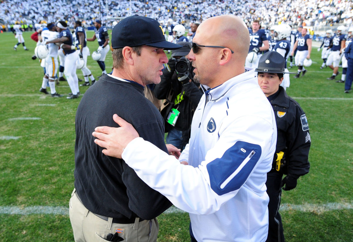 Michigan coach Jim Harbaugh and Penn State coach James Franklin shaking hands after a football game.