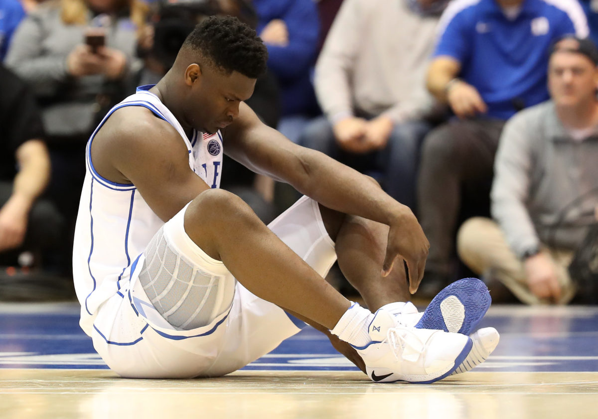 zion williamson looks at his shoes after getting hurt vs. unc