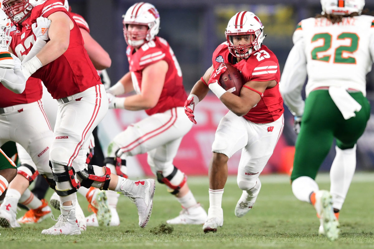 Jonathan Taylor rushes the ball against Miami in the Pinstripe Bowl.