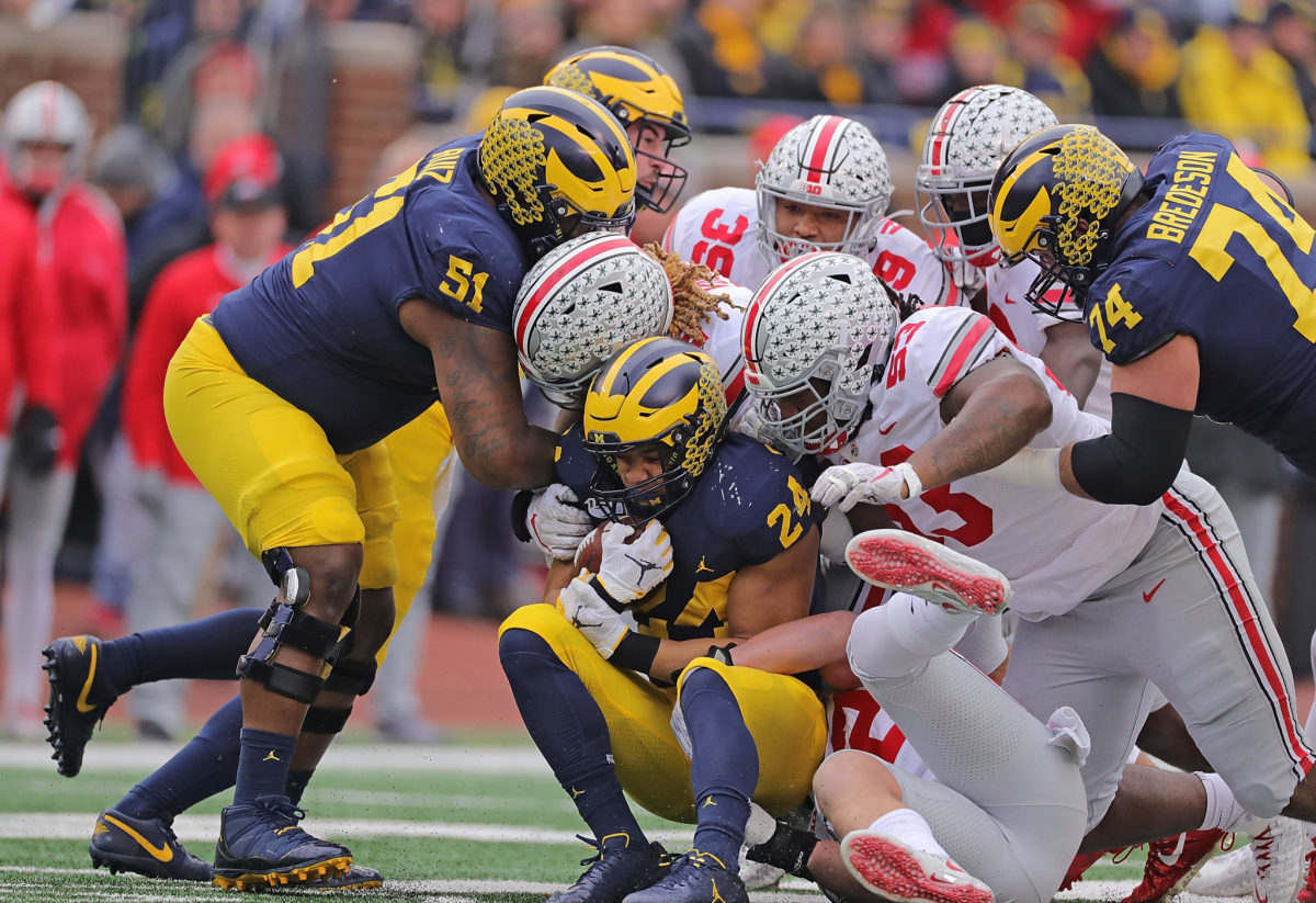 Big Ten rivals Ohio State and Michigan players during a college football game.