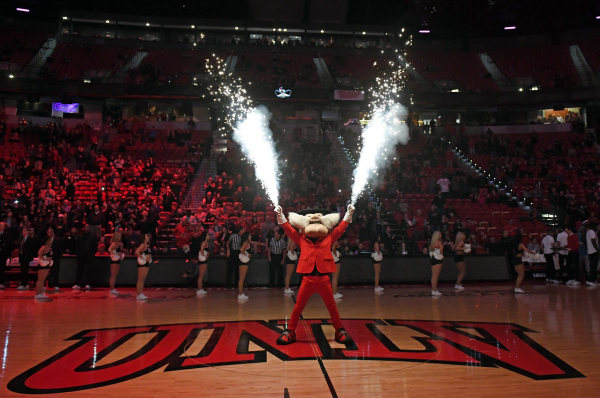 UNLV mascot Hey Reb shoots fireworks during basketball game.