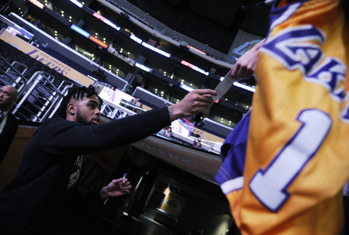 D'Angelo Russell hands a Lakers fan an autograph.