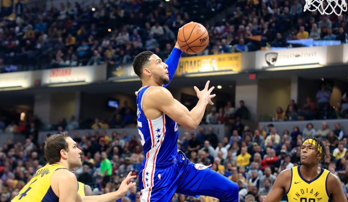 Ben Simmons going up for a dunk during a game.