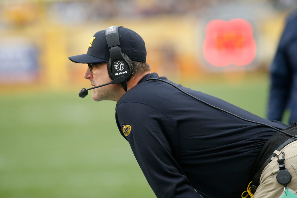 Jim Harbaugh looks on from the sidelines.