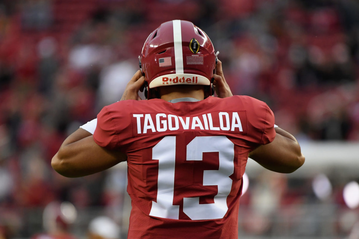 Tua Tagovailoa puts on his helmet at the national title game.