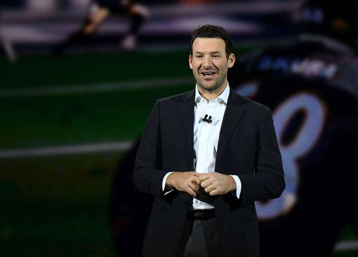 Tony Romo speaking at an event.
