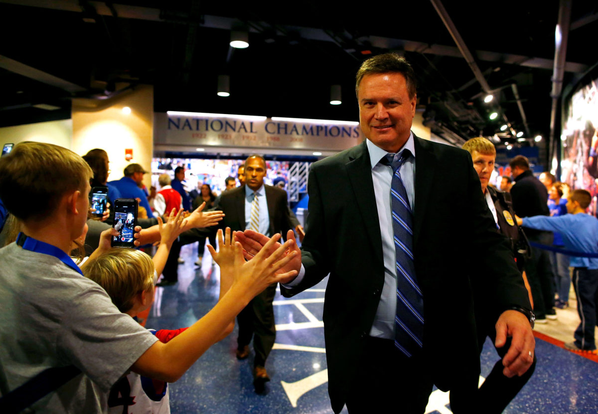 Bill Self interacting with fans before a kansas game.