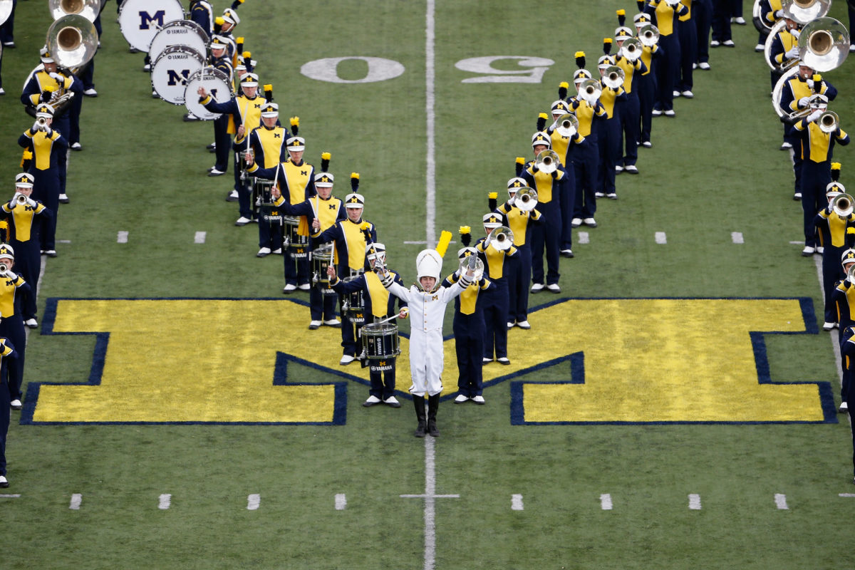 The Michigan Wolverines marching band performs before the college football game against the Michigan State Spartans at Michigan Stadium.